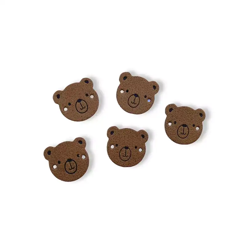 Lederlabel in Form eines Bärenkopfes